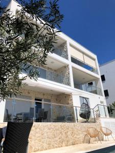 un condominio con balcone e sedie di Apartments Kovacev a Zara (Zadar)