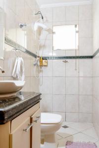 a bathroom with a sink and a toilet at Trem bão de dormir hostel in Belo Horizonte
