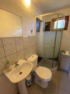 a bathroom with a white toilet and a sink at Cabañas Doña Juanita in San Pedro de Atacama