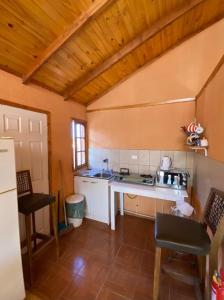 a kitchen with a white counter top in a room at Cabañas Doña Juanita in San Pedro de Atacama