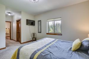 a bedroom with a bed and a window at Family-Friendly Lead Cabin Near ATVandSnowmobiling in Lead