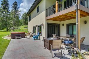 a patio with chairs and a table and a house at Family-Friendly Lead Cabin Near ATVandSnowmobiling in Lead