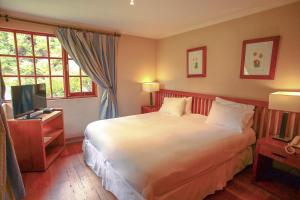 Postel nebo postele na pokoji v ubytování Hotel y Cabañas Palomar - Caja los Andes