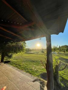 a view of a field with the sun in the distance at Las Potrancas cabaña in General Alvear