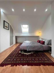 a bedroom with a bed and a rug at Home in the Heart of Manchester in Manchester