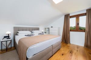 a white bedroom with a large bed and a window at Villa Trn in Cetingrad +43 photos