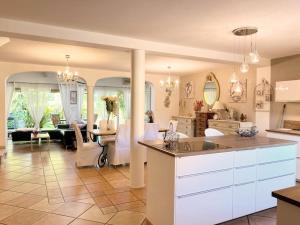 a large kitchen and living room with a dining room at Maison 120m² à 400 m de la plage in La Londe-les-Maures
