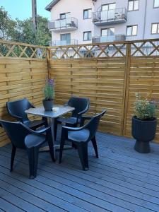 a patio with a table and chairs and a fence at Apartament Niko Nad Zatoką Pucką in Puck