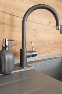 a kitchen sink with a black kitchen faucet at Villa Ivana in Ljubuški