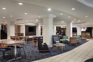 a lobby with tables and chairs in a library at Courtyard by Marriott Wichita at Old Town in Wichita