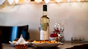 a bottle of wine sitting on a table with a glass at Mitato Eagle's Nest Peristeres in Níthavris