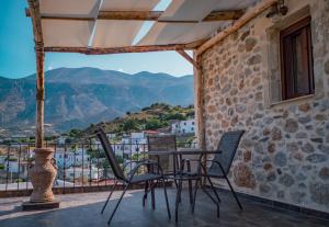 a table and chairs on a balcony with a view at Mitato Eagle's Nest Peristeres in Níthavris