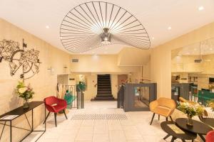 a lobby with chairs and tables and a chandelier at Quality Hotel Bordeaux Centre in Bordeaux