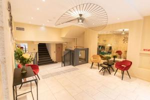 a lobby with chairs and tables and a staircase at Quality Hotel Bordeaux Centre in Bordeaux