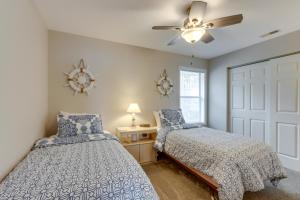 a bedroom with two beds and a ceiling fan at Lakefront Ozark Getaway with Views and Community Perks in Four Seasons