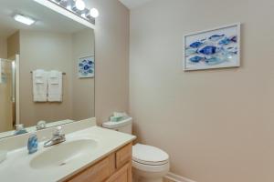 a bathroom with a sink and a toilet and a mirror at Lakefront Ozark Getaway with Views and Community Perks in Four Seasons +30 photos