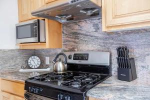 a stove in a kitchen with a tea kettle on it at Saikwan Valley Family Home in Milpitas