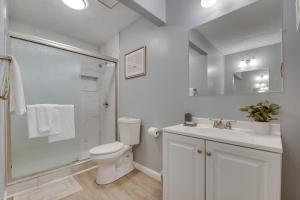a white bathroom with a toilet and a shower at Atlanta Getaway with Private Yard 3 Mi to Airport in College Park +16 photos