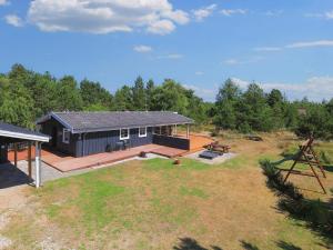 - une vue aérienne sur une maison noire avec une grande cour dans l'établissement 6 person holiday home in Blåvand-By Traum, à Blåvand
