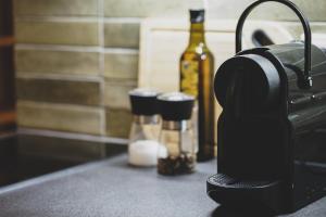 a hair dryer sitting on a counter with a bottle of wine at Modernes Wohlfühl-Apartment an den Kaiserthermen in Trier