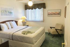 a hotel room with a bed and a chair at Wildwood Crest Beach House in Wildwood Crest