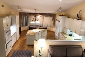 a large kitchen with white cabinets and a living room at Wildwood Crest Beach House in Wildwood Crest