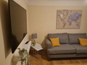 a living room with a couch and a table at Crabtree House in Moreton