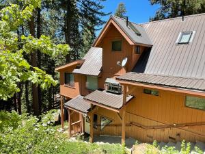 a house with a gambrel roof with solar panels on it at Chalet Yosemite in Yosemite West