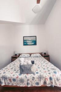 a bedroom with a bed with a comforter at Sunny Bay Apartments in Kotor