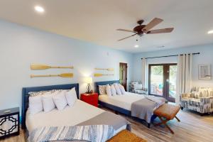 a bedroom with two beds and a ceiling fan at Abruzzi - Villa B in Eatonton 