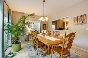 a dining room with a wooden table and chairs at Charming Wilmington Home with Patio about 7 Mi to Beach! in Wilmington