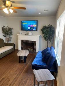 a living room with a couch and a fireplace at Quiet Comfort minutes from BOK and downtown Tulsa in Tulsa