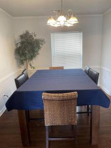 a dining room table with a blue table cloth on it at Quiet Comfort minutes from BOK and downtown Tulsa in Tulsa