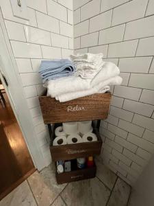 a rack of towels and toiletries in a bathroom at Quiet Comfort minutes from BOK and downtown Tulsa in Tulsa