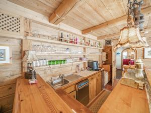 a kitchen with a sink and a wooden wall at Maria Rose XXL in Kirchberg in Tirol