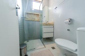 a bathroom with a toilet and a glass shower at apartamentos Coração Eucarístico in Belo Horizonte