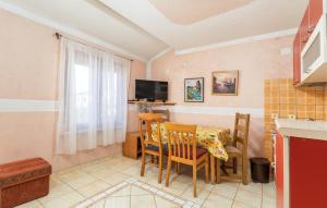 a kitchen with a table and chairs and a television at Apartments and rooms with parking space Fazana - 13742 in Marana