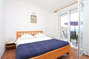 Postel nebo postele na pokoji v ubytování Apartment Baska Voda 300c