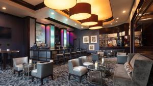 a bar in a restaurant with chairs and tables at Ultimate Las Vegas Getaway One Bedroom Suite with Balcony, Kitchen, Gym, Pool & Free Parking in Las Vegas