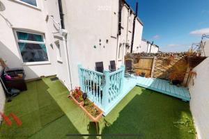 an aerial view of a house with a blue balcony at New Brighton Beach in Wallasey