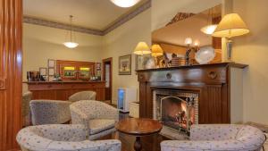 a living room with chairs and a fireplace at Royal Exchange Hotel in Broken Hill
