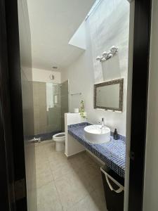 a bathroom with a sink and a toilet at Zen Home in Tulum +16 photos
