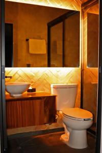 a bathroom with a toilet and a sink at Layoo, Tu casa en Oaxaca 102 in Oaxaca City +9 photos