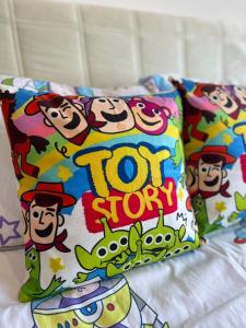 a pillow with toy story on it on a bed at Lost World Of Tambun Coco Guest House in Ipoh