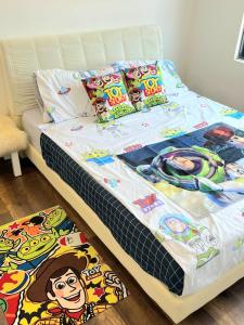a bed with toy story pillows on top of it at Lost World Of Tambun Coco Guest House in Ipoh