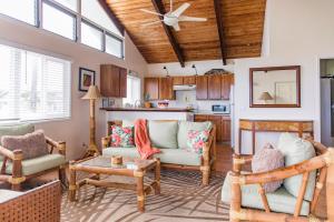 a living room with furniture and a ceiling fan at OceanFront Kauai - Rhythm TVNC 4288 in Kapaa