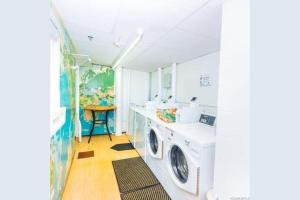 a laundry room with a washer and dryer at Waikiki condo -18F in Honolulu