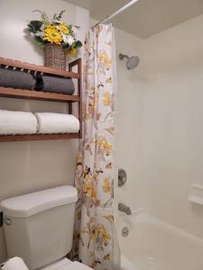 a bathroom with a toilet and a shower with a shower curtain at Waikiki condo -18F in Honolulu