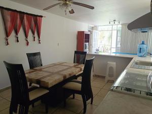 a kitchen with a table and chairs in a room at Estancia Santa Fe in Celaya +22 photos
