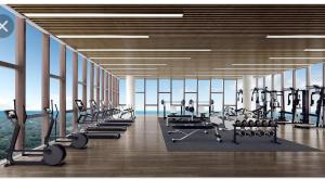 a gym with a row of treadmills and machines at Aisyah Mutiara Bali Residence Melaka in Malacca